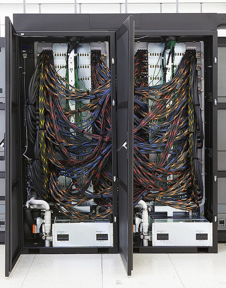 Back view of two Piz Daint supercomputer cabinets with their interconnection cables.